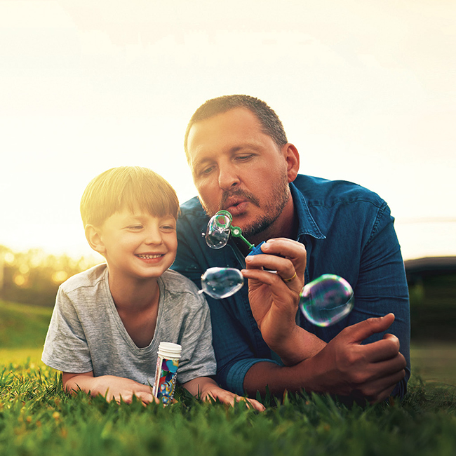 Dad and son playing in the park