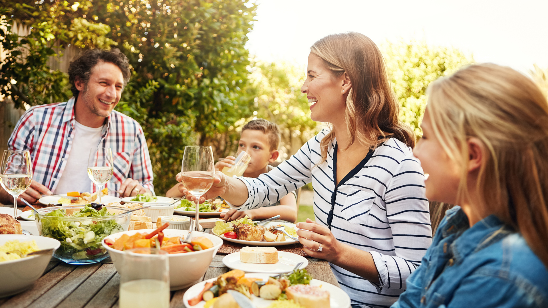 Family having dinner in their backyard.