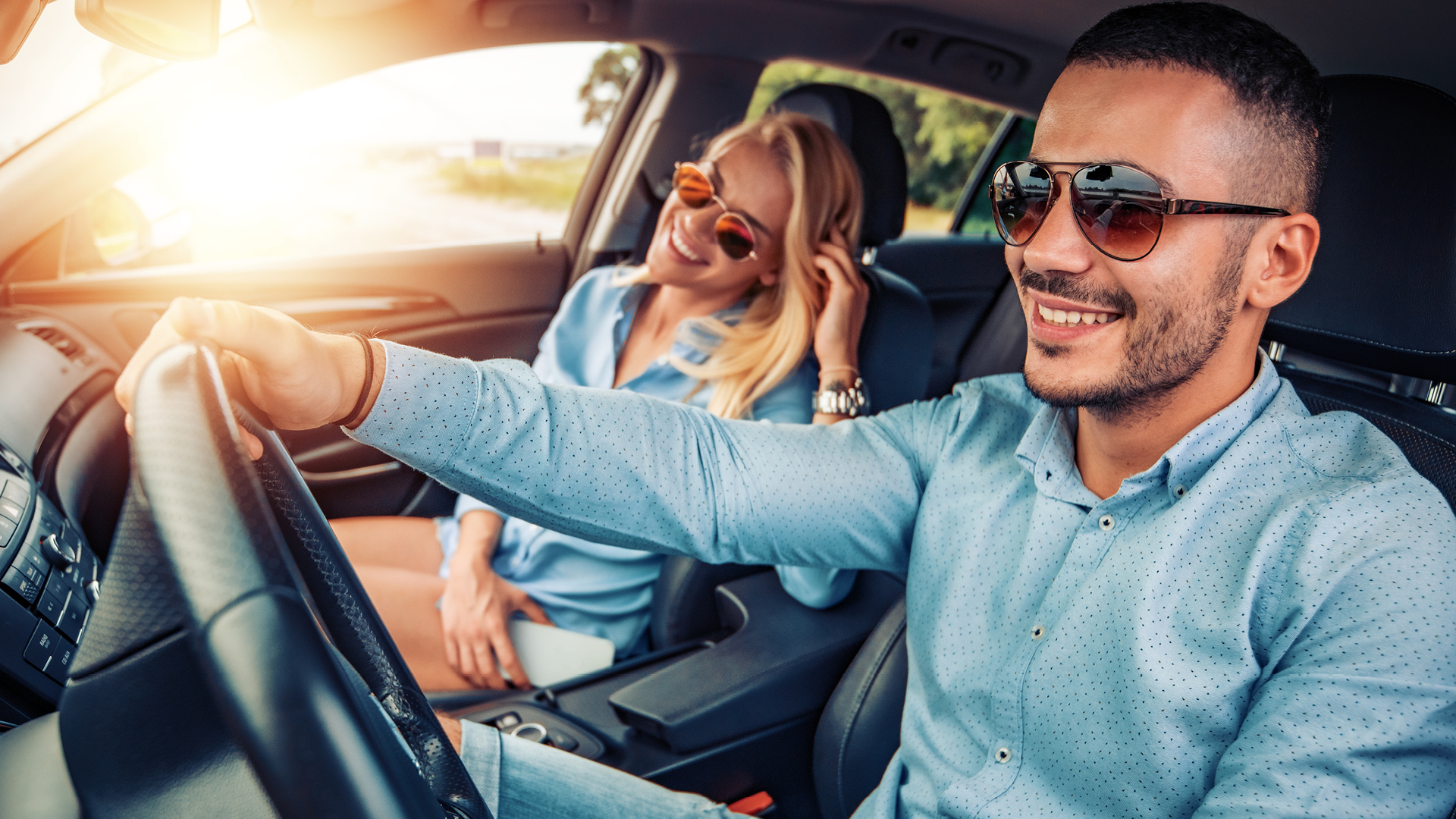 Happy couple driving car