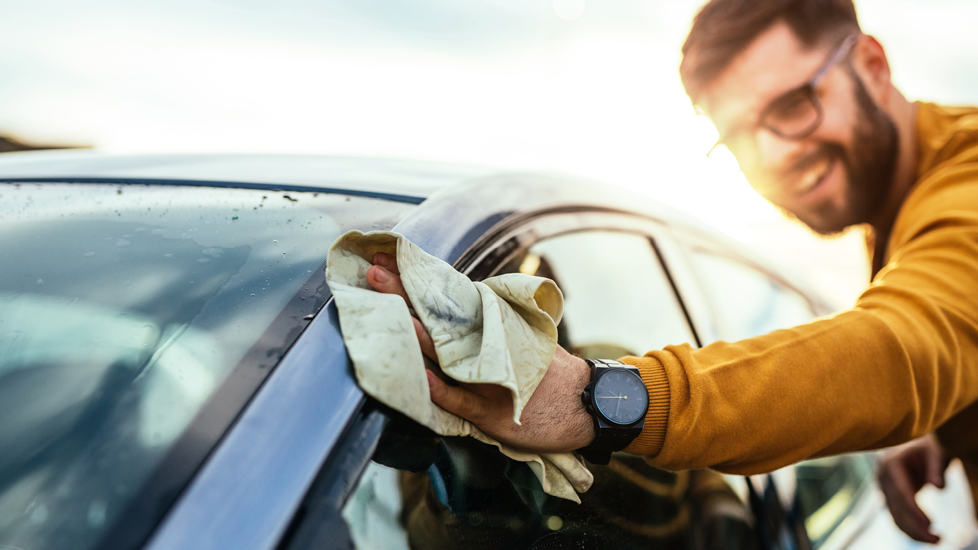 Man washing his new car purchased with a SESLOC auto loan.