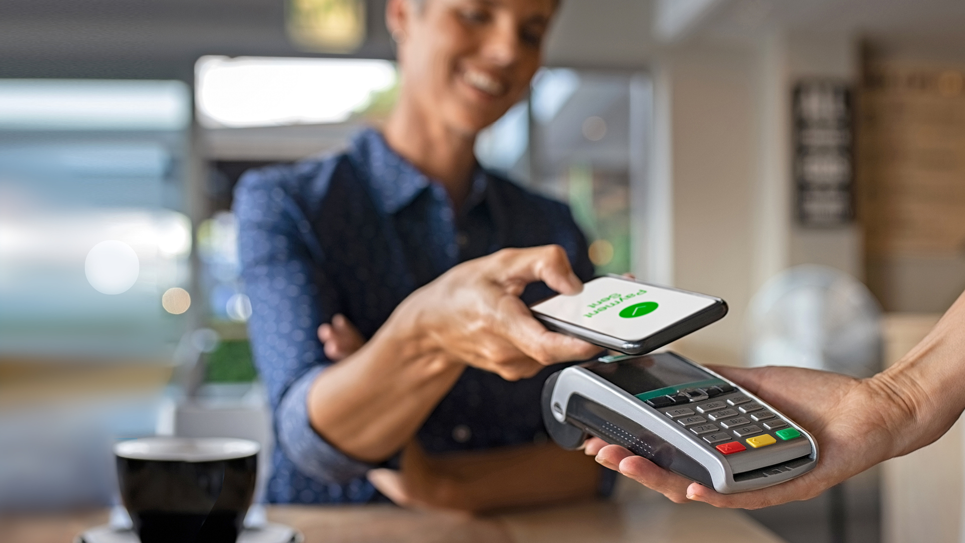 Woman making a contactless payment.