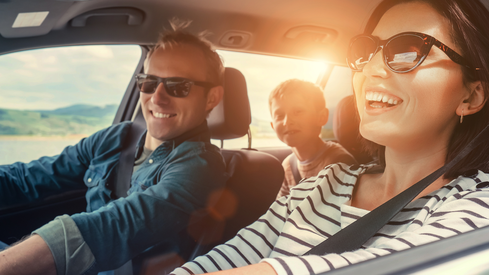 A family driving in their car, enjoying SESLOC's HomeFREE Discount Program.