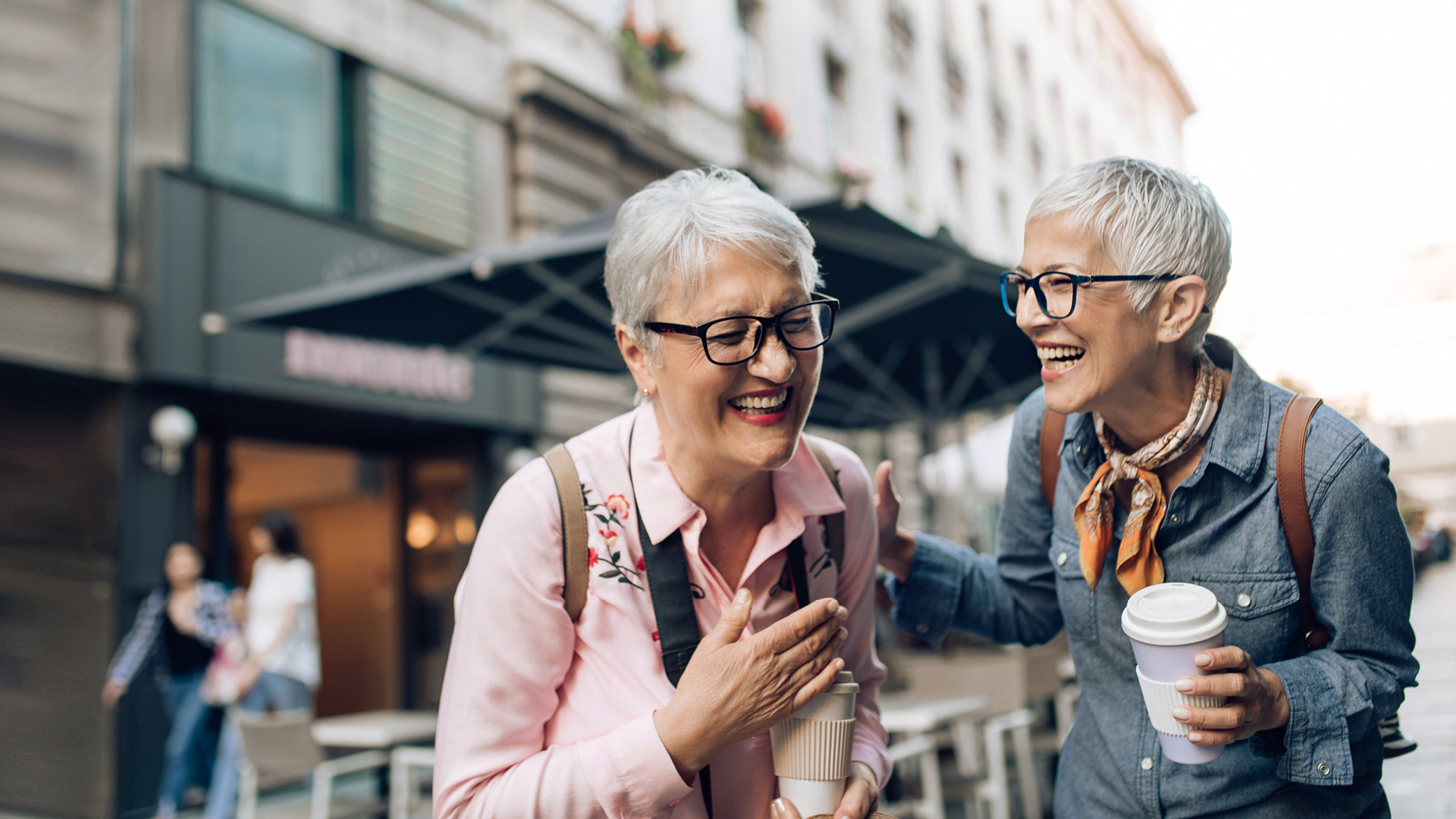 Senior women out shopping downtown with their SESLOC Visa credit cards.