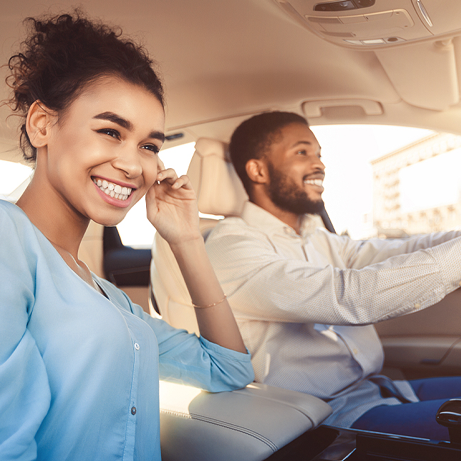 Happy couple driving car.