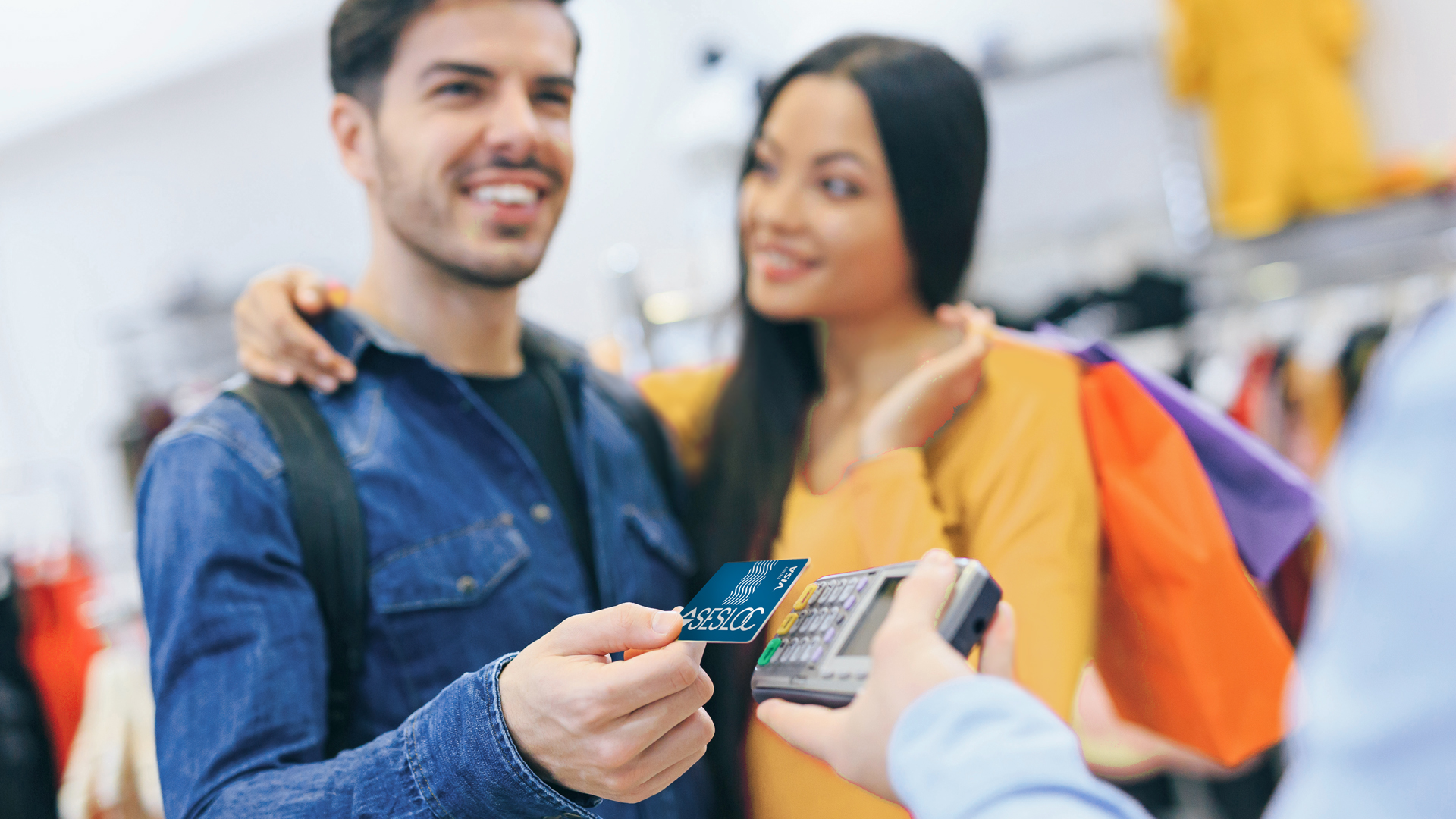 A couple is shopping with their SESLOC Basic Checking debit card.