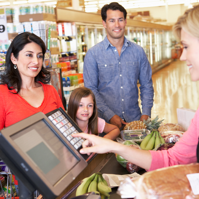 A family is grocery shopping with their SESLOC debit card.