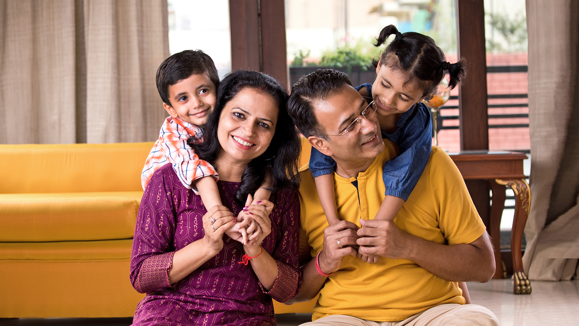 A family enjoys their new home, courtesy of a SESLOC FHA Home Loan.