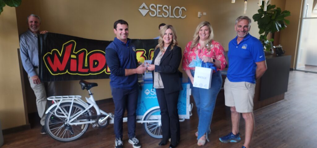 Nico Calanchini, Blues General Manager, accepts SESLOC Young Changemakers award with SESLOC staff