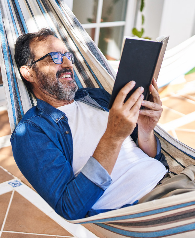 man reads in hammock